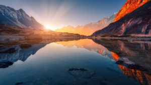 Sun rising over mountains